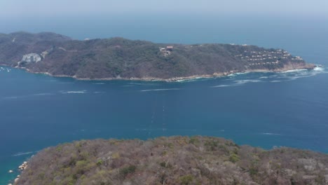 Aerial-View-of-Zipline-Cables-Over-Coast-and-Pacific-Ocean-in-Acapulco-Bay,-Mexico