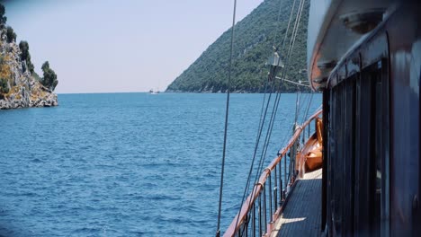 Boat-traveling-in-the-calm-waters-of-the-Mediterranean,-view-from-port-side