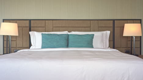 Tilt-up-from-the-foot-of-a-hotel-resort-bed-to-the-wood-patterned-headboard