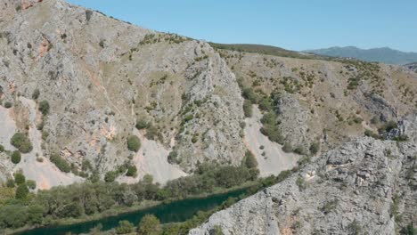 Aerial-reveal-view-flying-above-Zrmanja-river-canyon-wilderness-valley,-Croatia