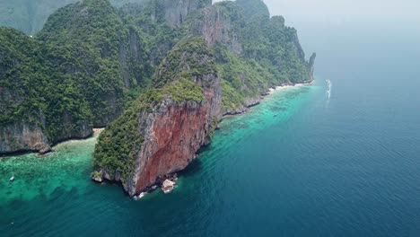 Tropical-Paradise,-Remote-Koh-Phi-Phi-Leh-Island,-Backside-of-Maya-Bay-Beach-Lagoon,-Aerial-View-of-Limestone-Cliffs-Over-Blue-Sea