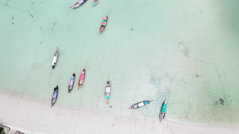 Luftaufnahme-Von-Oben-Nach-Unten-Auf-Traditionellen-Booten-Im-Seichten-Wasser-Von-Koh-Phi-Phi-Don-Island-Beach,-Thailand