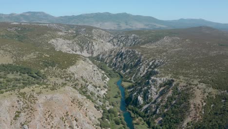 Zrmanja-river-canyon-rising-tilt-down-aerial-view-above-mountain-gorge-landscape
