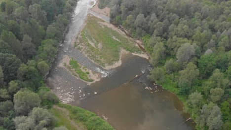 Aerial-overhead-of-flowing-river-in-Europe-that-appears-to-be-drying-up