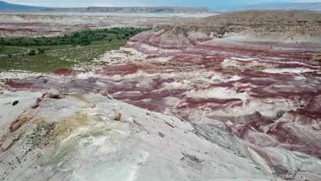 Aerial-View-of-Amazing-Utah-Desert-Landscape,-Layered-Sandstone-Formations-amd-Hills-Near-Hanksville