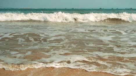 Slow-motion-waves-in-tropical-ocean-with-blue-sky-and-white-sand