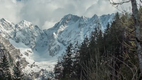 Snow-covered-Alp-mountain-peak-scene,-sunny-day---PANNING-RIGHT