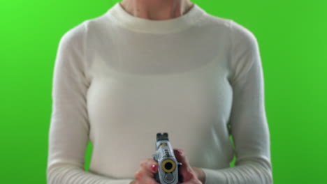 Female-pointing-gun-forward,-cocking-and-firing-on-green-screen-background