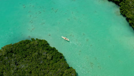 Aerial-Drone-Shot-Top-Down-Camera-of-Lone-Kayaker-paddling-Along-the-River-with-Colorful-Turquoise-Water