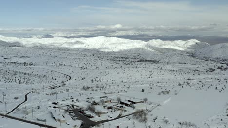 Aerial-view-above-snowy-white-covered-town-community