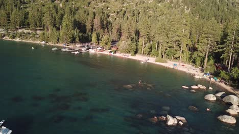 Recreation-Area-and-Coniferous-Forest-on-Coast-of-Lake-Tahoe-USA,-Aerial-View-on-Sunny-Summer-Day