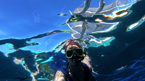 Hand-handled-gopro-of-caucasian-snorkeling,-thumbs-up-for-the-nice-clear-sea-water-of-Cebu,-Philippines