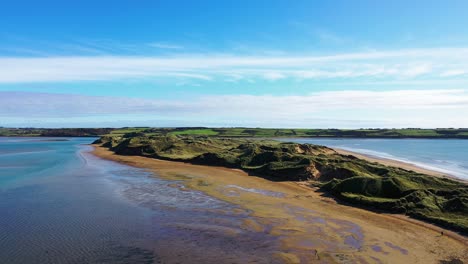 Drone-flying-over-The-Sandhills-at-Tramore-Beach,-Ireland,-dolly-movement