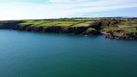 Aerial-flying-over-ocean-near-Newtown-Cove-in-Waterford,-Ireland,-truck-right