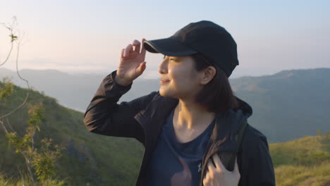 Slow-Motion-Profile-Shot-Of-Young-Asian-Woman-Climbing-A-Mountain-During-Sunrise