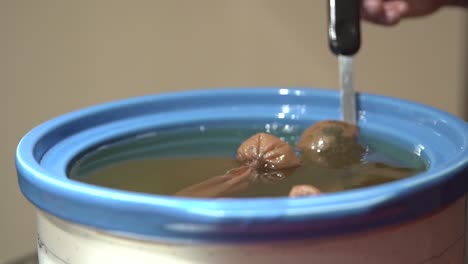 Stirring-the-coconut-oil-to-aid-with-the-extraction-of-CBD-from-the-cannabis-buds