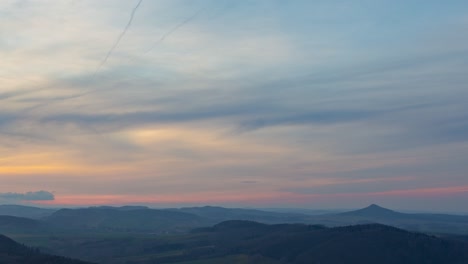 Time-lapse-of-sunset-clouds-over-Ostrzyca-Proboszczowicka-mountain