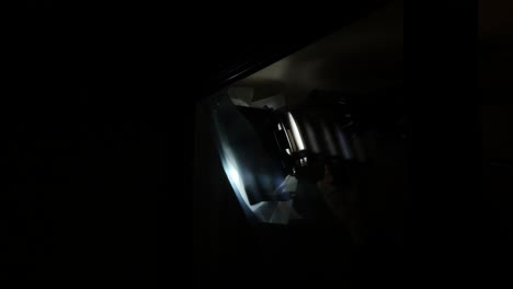 Adjusting-professional-studio-lights-in-a-dark-room