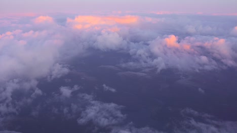Beautiful-panoramic-aerial-view,-shot-above-the-clouds-of-a-sunset