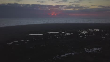 Aerial-view-of-sunset-on-Whatipu-Beach-in-Auckland,-New-Zealand