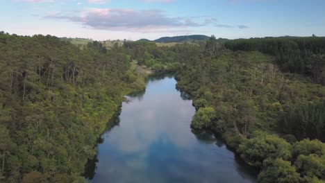 Aerial-flyover-of-the-calm-waters-of-the-Waikato-River-in-Taupo,-New-Zealand