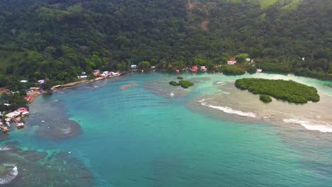 Aerial-orbit-view-across-Panama-lush-tropical-jungle-island-resort-coastline-wilderness---turquoise-bay