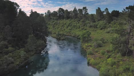 Flyover-of-the-Waikato-River-in-Taupo,-New-Zealand,-tilt-down