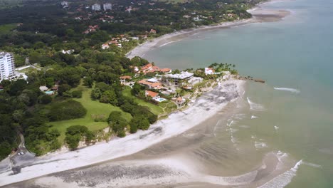 Aerial-view-dolly-right-across-Costa-Esmerelda-exotic-Panama-island-palm-tree-jungle-coastline-beach-resorts