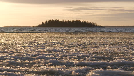 Calm-natural-rhythm-concept,-winter-waves-moving-thin-ice-at-shoreline