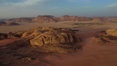 Wadi-Rum-rocks-in-Valley-of-the-Moon-at-sunset,-Jordan,-high-aerial-view