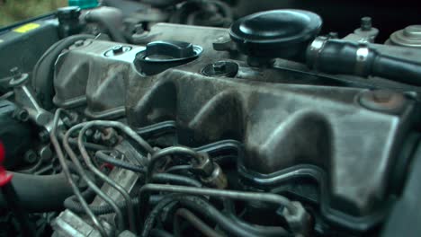 Working-engine-of-the-old-car-under-the-open-hood