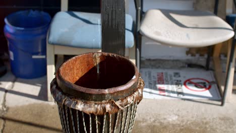 Water-drips-in-wooden-basket-and-chairs-in-the-background