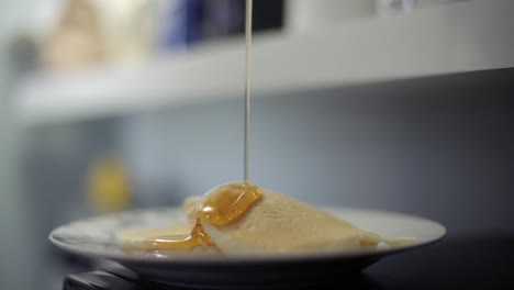 CBD-THC-infused-cannabis-oil-syrup-poured-over-pancakes-in-slow-motion