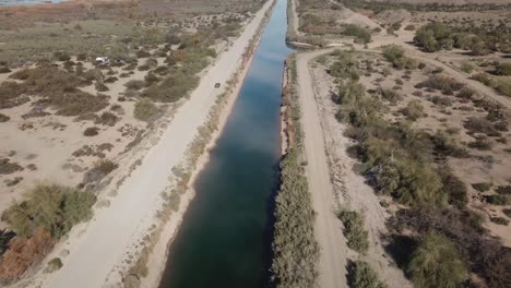 Drone-aerial-view-of-vehicle-driving-along-the-Gila-Gravity-Canal---Yuma-Irrigation-District-in-southern-Arizona