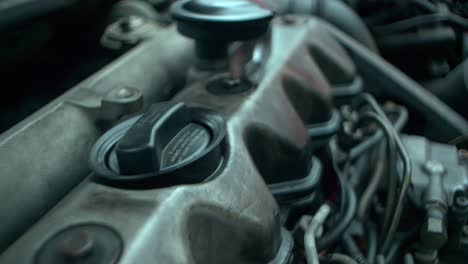 Working-engine-of-the-old-car-under-the-open-hood