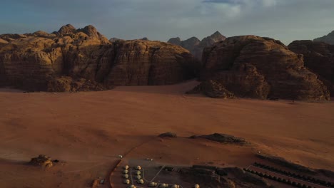 Wadi-Rum-valley-and-luxury-camping-pods-resort-in-Jordan,-drone-view