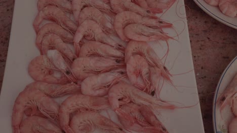 Plate-of-boiled-pink-shrimp,-Slow-Motion-Closeup-Spinning-Top-Shot