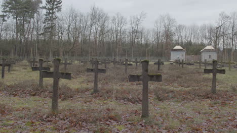 Tilt-down-from-grey-sky-to-old-crosses-at-cemetery