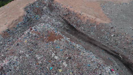 Aerial-shot-ascending-to-reveal-a-large-Landfill-site,-ecological-problem