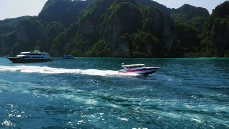 Tracking-shot-of-Speedboat-moving-through-deep-blue-sea-at-Ko-Phi-Phi-island-in-Thailand