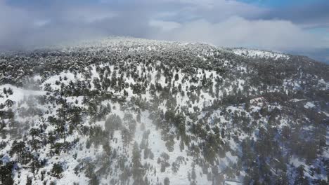 Wide-aerial-panning-shot-of-Troodos-Mountain-covered-in-fresh-snow