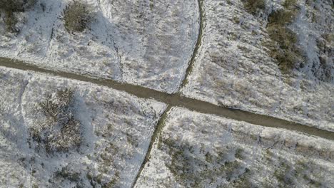 A-hiking-trail-through-the-snow-covered-landscape-in-Granada,-Spain---top-view