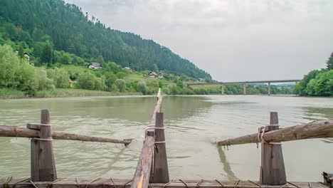 Slow-motion-of-man-rowing-on-a-timber-rafting-wharf-at-a-Slovenian-event-in-Drava-River