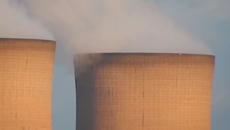 Industrial-cooling-tower-power-station-chimneys-smoking-steam-pollution,-close-up-as-birds-fly-through-scene.