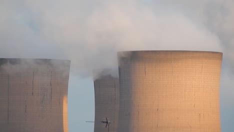 Industrial-cooling-tower-power-station-chimneys-smoking-steam-pollution,-close-up-smoke-blowing-left.