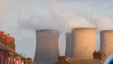 Industrial-cooling-tower-power-station-chimneys-smoking-steam-pollution,-close-up-from-residential-area.