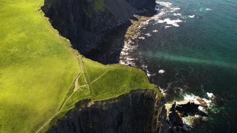 Cliffs-of-Moher-dramatic-clifftop-precipice,-aerial-birds-eye-view-reveal
