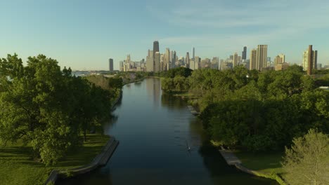 Aerial,-Pan-Up-to-Reveal-Chicago-Skyline-with-People-Rowing-in-Lincoln-Park