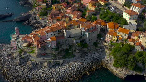 Aerial-zoom-in-shot-of-of-beautiful,-colorful,-coastal,-Ligurian-village-of-Tellaro,-Italy