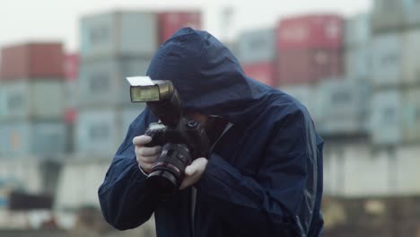 Crime-scene-investigator-taking-photos-of-murdered-person-in-harbor,-front-view